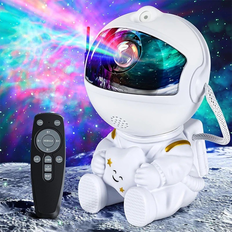 White astronaut galaxy star projector hugging a star, shown with its remote control